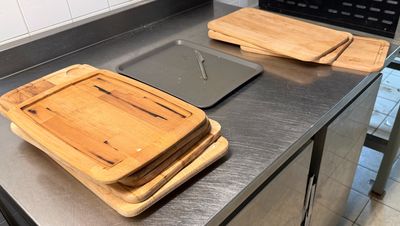 two wooden cutting boards on the counter in the kitchen