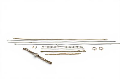 an assortment of brass and silver jewelry on a white background