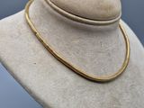 a close up of a hat on a mannequin with a necklace on it