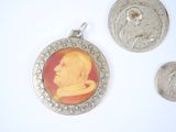 two silver coins with a picture of a man on them and a coin with a picture of a man on it
