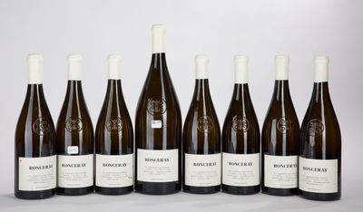 six bottles of wine are lined up in a row
