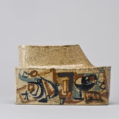 a close up of a piece of pottery with graffiti on it