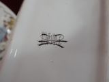 a close up of a white plate with a design on it