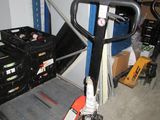 a picture of a forklift in a garage next to a stack of boxes