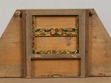 a small wooden box with a picture of a bird on it