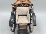 an old fashioned horse drawn carriage with a seat and foot rest
