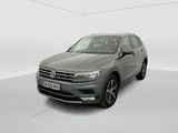 a grey volkswagen tiguan parked in a white room