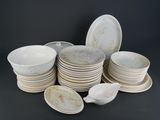 a lot of plates and bowls sitting on a table