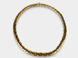a close up of a gold bracelet on a white background
