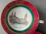 a cup and saucer with a picture of a bridge on it