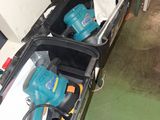 deux outils électriques dans un coffret posé par terre