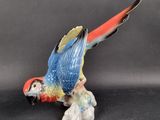 a figurine of a parrot sitting on top of a table