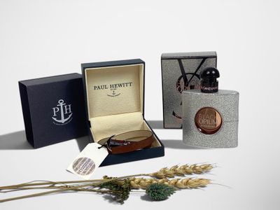 a small box with a watch and a bottle of perfume
