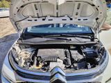 a car with its hood open and the engine in the trunk