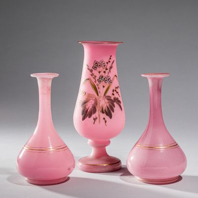 three pink vases sitting on top of a table next to each other