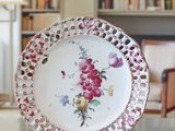 a plate with a floral design on it sitting on a table
