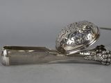 a silver spoon with a spoon rest on top of it