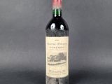an old bottle of wine sitting on top of a table