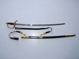 two swords with gold and black handles on a white surface