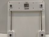 an image of a white bathroom scale on a counter