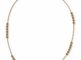 a gold necklace with small beads on a white background