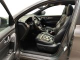 the interior of a car with the door open and the driver ' s seat down