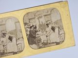 an old photo of a group of people sitting around a table