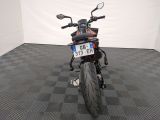 a motorcycle that is parked in a room with a checkered floor