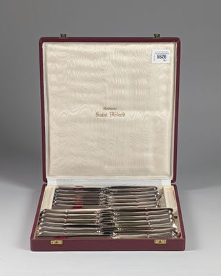 a set of six silverplated flatware knives in a case