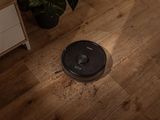 the roombake is sitting on the floor next to a potted plant