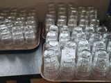 a lot of empty glasses sitting on a table