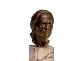statue of a woman ' s head on a marble block