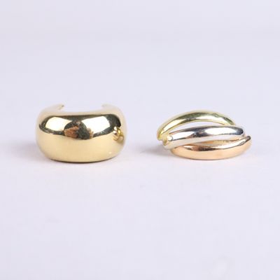 two gold and silver rings sitting on top of each other