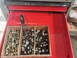 a red drawer that has a bunch of assorted items in it