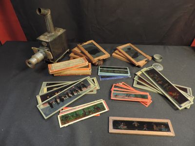 a pile of old photos and a camera on a table