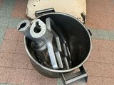 an image of a metal bowl with tools inside of it