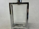the bottle of cologne is empty on a white surface
