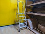 a ladder leaning against a yellow wall in a room