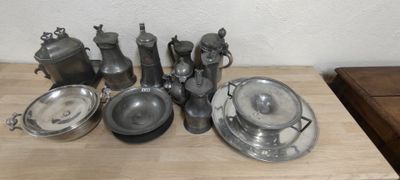 a lot of silver items sitting on a wooden table