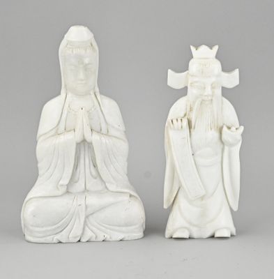 two white statues of buddhas with a crown on their heads
