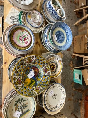 many plates and bowls that are on a table