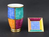 a colorful vase and a picture frame on a black background