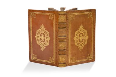 un vieux livre orné d'un motif doré sur la couverture