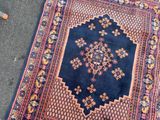 a rug on the ground next to a pair of orange shoes