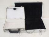 two suitcases that are open on a white surface
