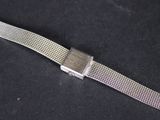 a watch that is laying on a black surface
