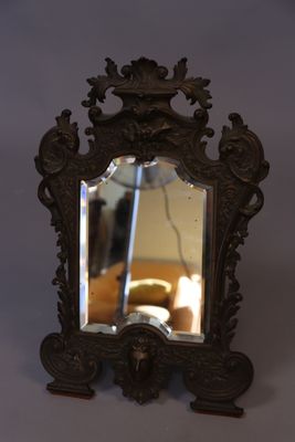 a mirror that is sitting on a table next to a couch