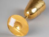 pair of gold plated vases on a white surface