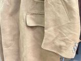 a coat hanging on a clothes rack in a store