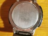 a close up of a watch on a wooden table